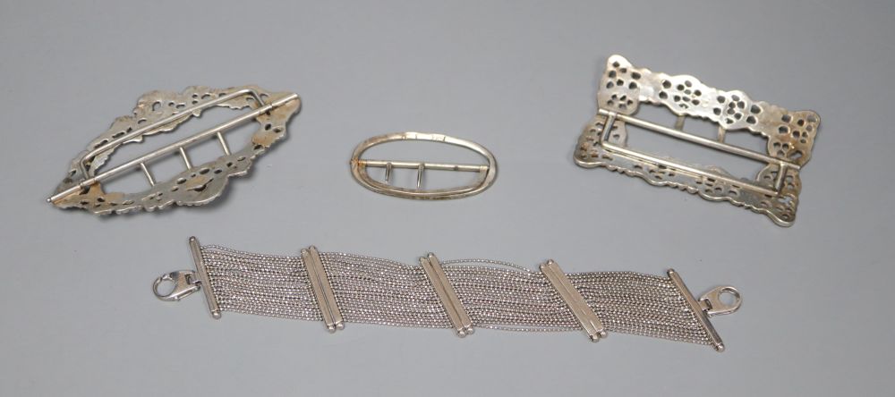 Three silver belt buckles and an Italian silver bracelet.